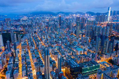 High angle view of illuminated city buildings against sky