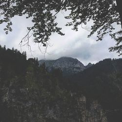 Scenic view of mountains against cloudy sky