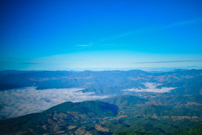 Scenic view of dramatic landscape against blue sky