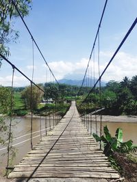 Traditional bamboo suspension bridge
bridge over river against sky