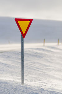 Close-up of red umbrella on beach