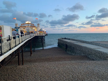 Pier over sea against sky during sunset