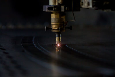 Close-up of illuminated machine in factory