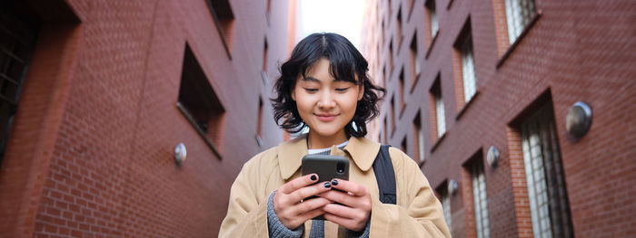 Young woman using mobile phone