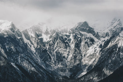 Close-up of snow on mountain against sky