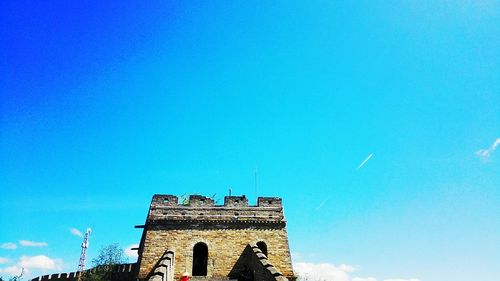 Low angle view of tower against blue sky