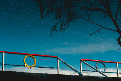 Low angle view of swimming pool against blue sky