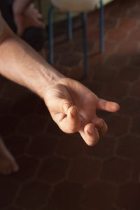 Low section of man holding insect