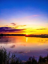 Scenic view of lake at sunset