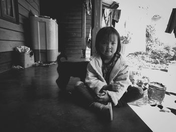 Portrait of girl sitting on table