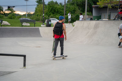 Rear view of man skateboarding on skateboard