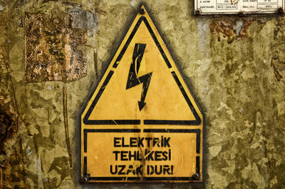 Close-up of information sign on wall