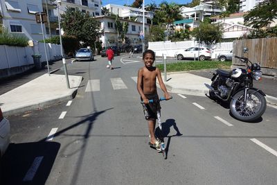 Full length of man riding motorcycle on street