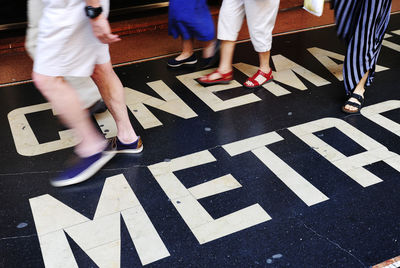 Low section of people walking on street