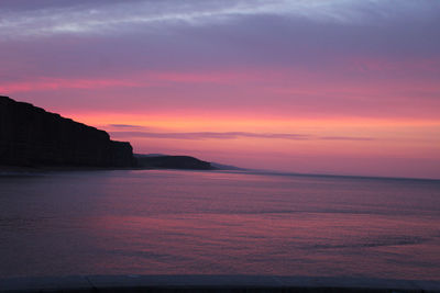 Scenic view of sea against romantic sky at sunset