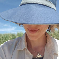 Close-up of woman wearing hat while smiling outdoors