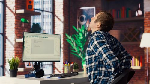 Side view of woman using digital tablet while standing in office