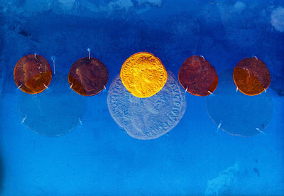 High angle view of fruits on blue surface