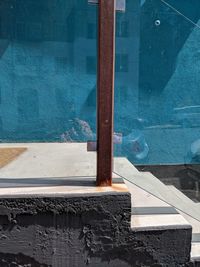 Close-up of closed window of swimming pool against building