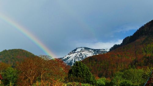 Rainbow over mountain against sky