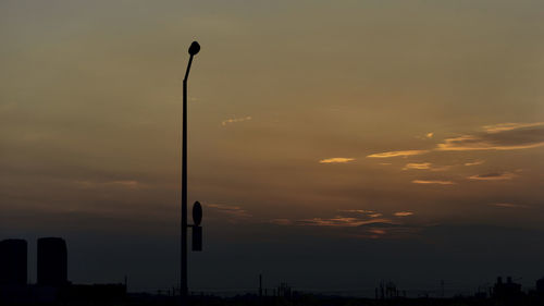 Low angle view of street light against sky at sunset