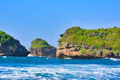 Scenic view of sea against clear blue sky