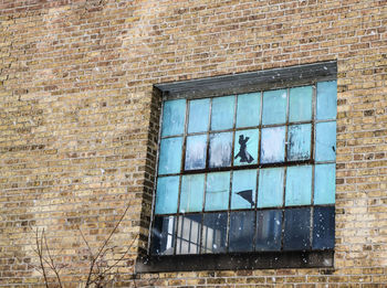 Low angle view of window on wall of building