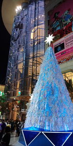 Low angle view of illuminated christmas lights in city at night