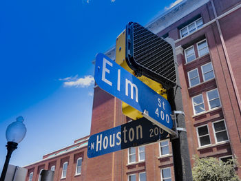 Low angle view of information sign against buildings in city