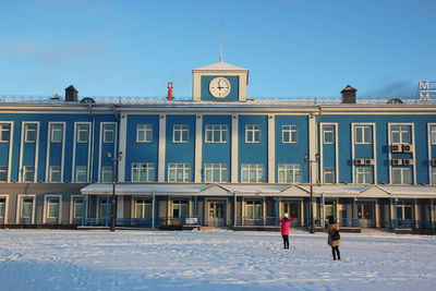 People in front of building in winter