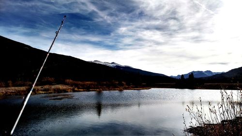 Scenic view of calm lake against cloudy sky