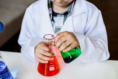 Midsection of woman working in bottle