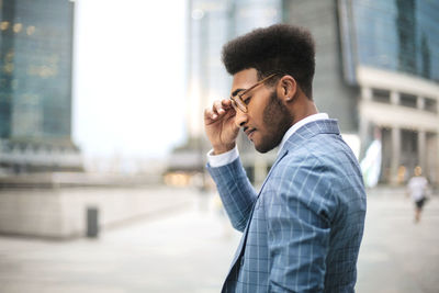 Young man looking at city