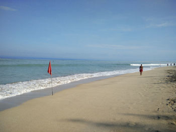 People walking on calm beach