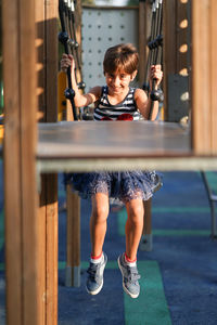 Portrait of girl enjoying on play equipment