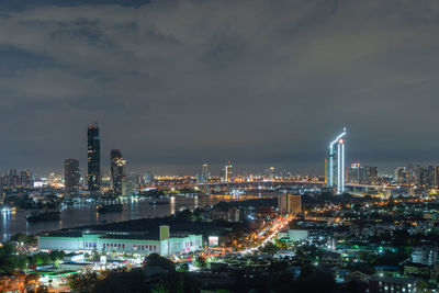 Illuminated city against sky at night