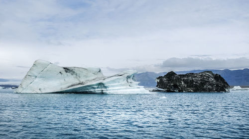 Scenic view of sea against sky with ice 