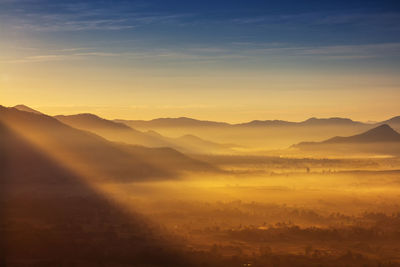 Scenic view of silhouette mountains against sky during sunset