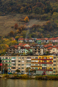 Buildings by river in city