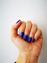 Close-up of woman hand over white background