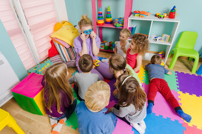 High angle view of people sitting on multi colored stage