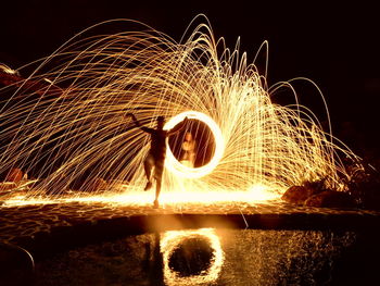 Blurred motion of ferris wheel at night