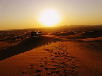 Scenic view of desert against sky during sunset