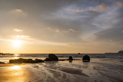 Scenic view of beach against sky during sunset