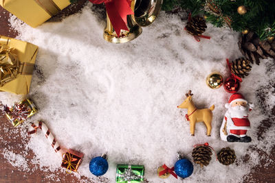 Close-up of christmas decorations with fake snow on table