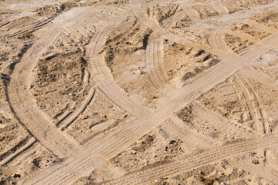 Aerial view of tire tracks on sand