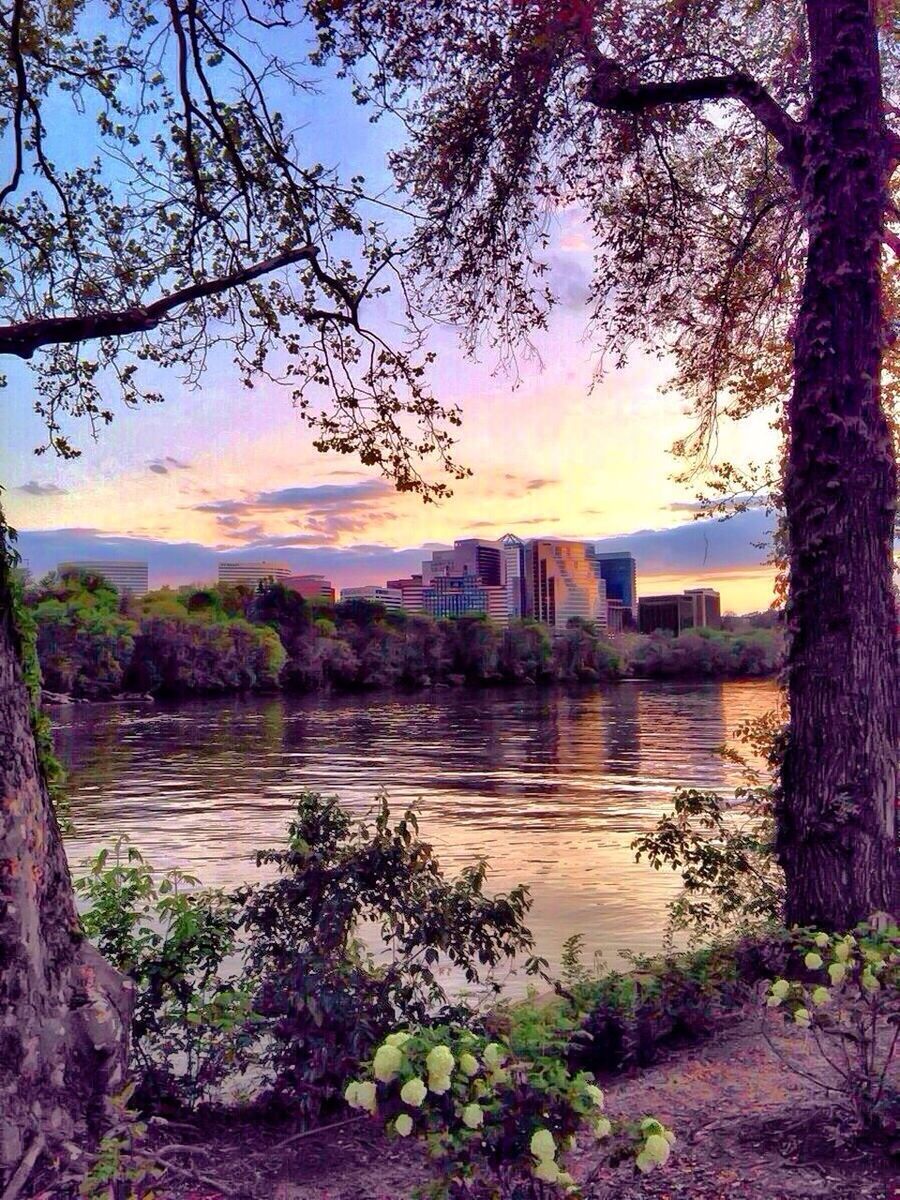 architecture, built structure, water, sunset, building exterior, sky, tree, river, tranquility, scenics, tranquil scene, beauty in nature, nature, lake, city, reflection, cloud - sky, no people, outdoors, orange color