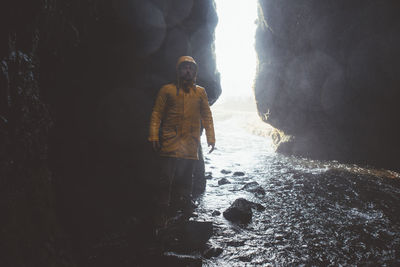 Full length of man standing in cave