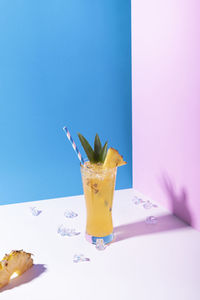 Close-up of drink on table against blue background