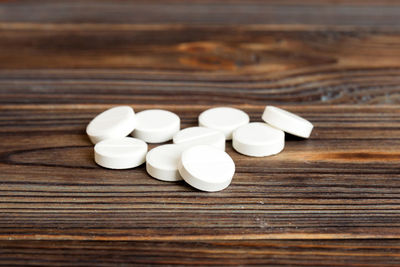 Close-up of pills on wooden table